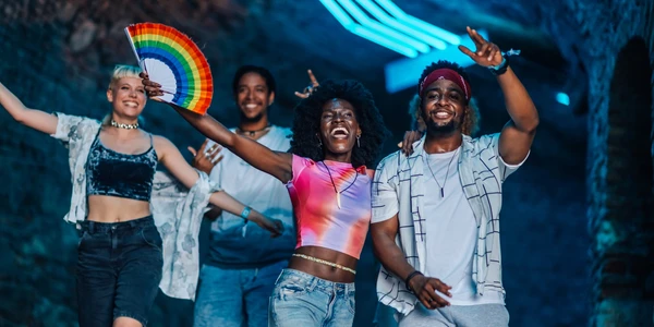 Happy LGBTQ youth with a pride flag