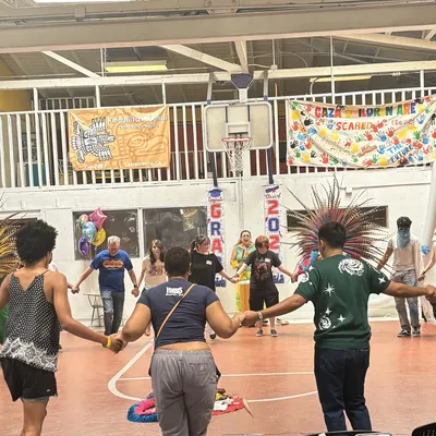 LGBTQ Youth dancing in a circle